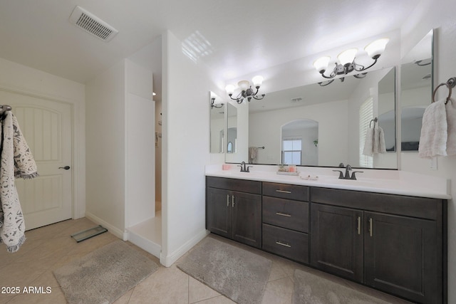 bathroom with visible vents, walk in shower, a sink, and tile patterned floors