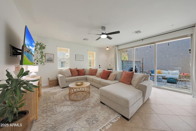 tiled living room with ceiling fan and visible vents