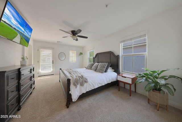 carpeted bedroom with ceiling fan, multiple windows, and access to outside