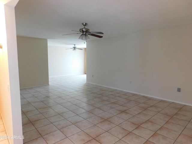unfurnished room with baseboards and ceiling fan