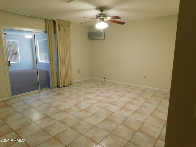 unfurnished room with baseboards, a wall mounted AC, and a ceiling fan