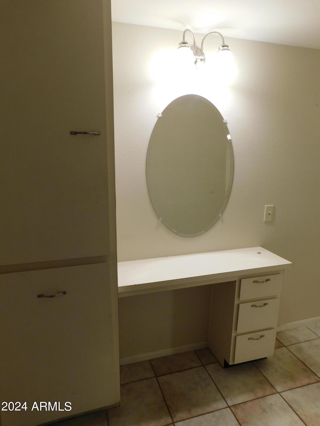 bathroom with baseboards, tile patterned flooring, and vanity