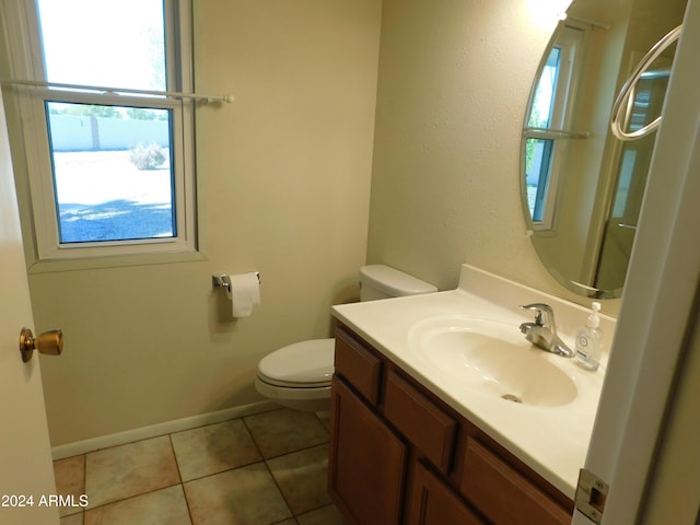 bathroom with baseboards, toilet, tile patterned flooring, and vanity