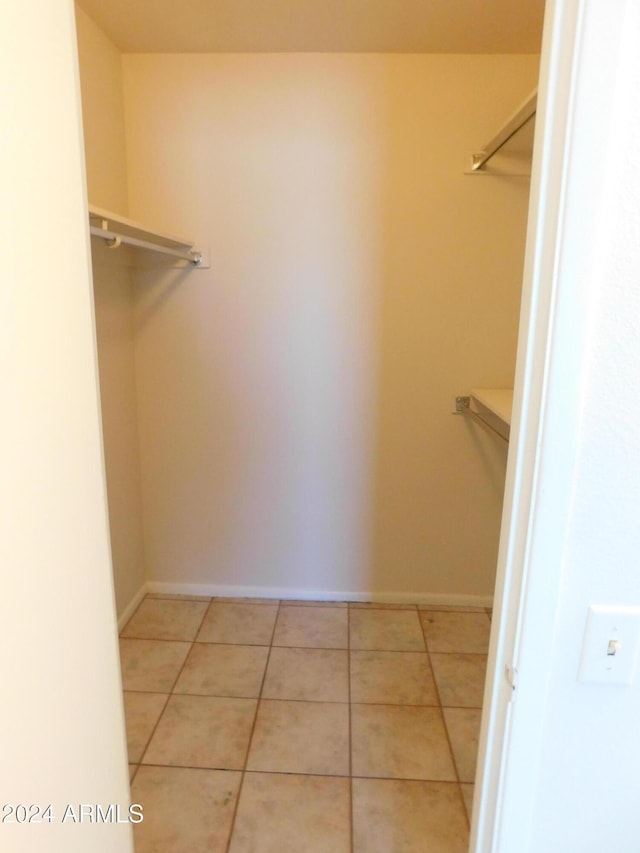 walk in closet featuring light tile patterned floors
