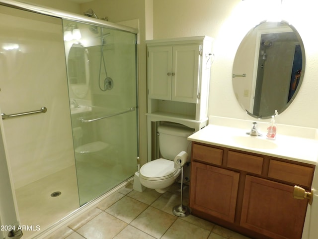 full bathroom featuring vanity, toilet, tile patterned floors, and a shower stall