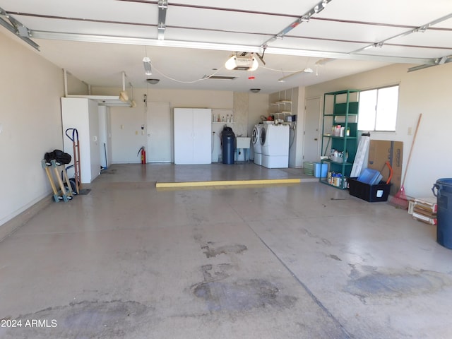 garage with washer and clothes dryer and a garage door opener