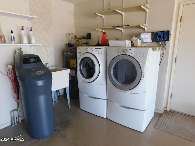 laundry area featuring washing machine and dryer and water heater