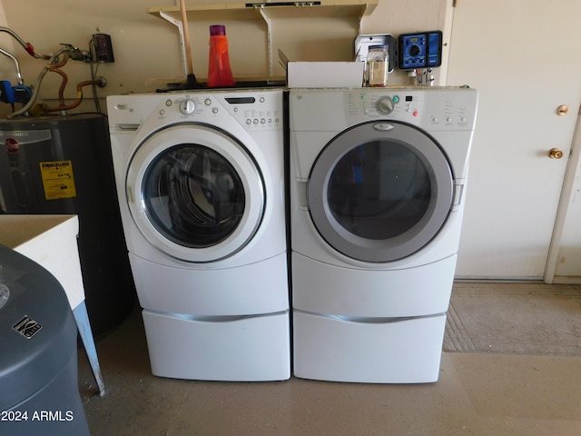 laundry room featuring water heater and washer and clothes dryer