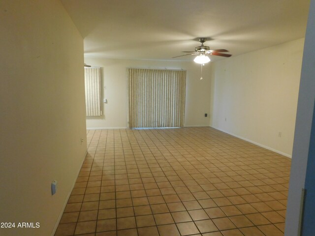 empty room featuring ceiling fan and light tile patterned flooring