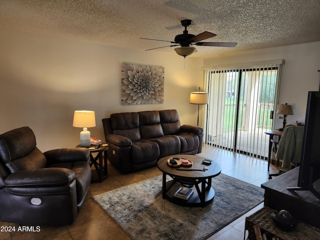 living room with tile floors, ceiling fan, and a textured ceiling