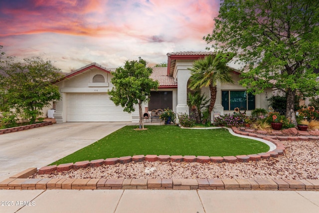 view of front of home with a front yard, driveway, stucco siding, a garage, and a tiled roof