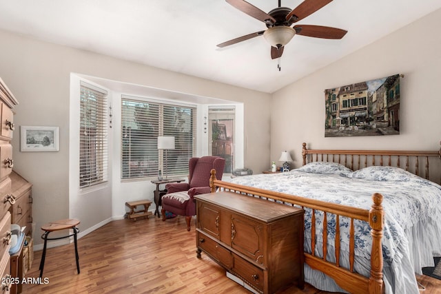 bedroom with baseboards, a ceiling fan, light wood-style floors, and vaulted ceiling