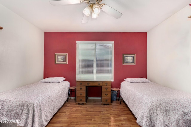 bedroom with ceiling fan and wood finished floors