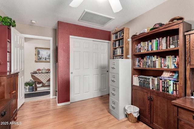 interior space with light wood-style flooring, visible vents, and a closet