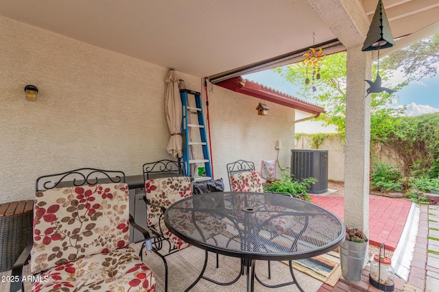 view of patio / terrace featuring outdoor dining space, cooling unit, and fence