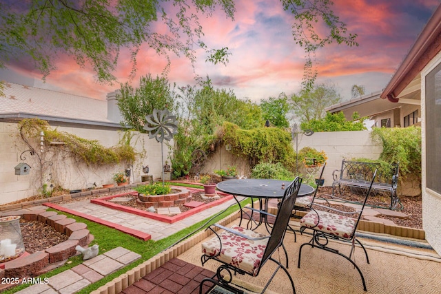 view of patio with outdoor dining area and a fenced backyard