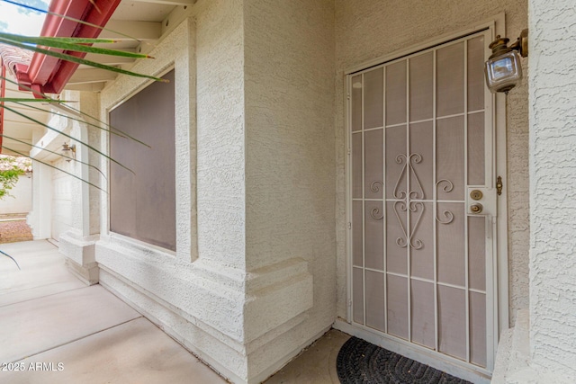 entrance to property featuring stucco siding