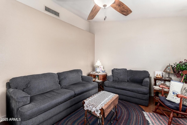 living area with wood finished floors, a ceiling fan, and visible vents