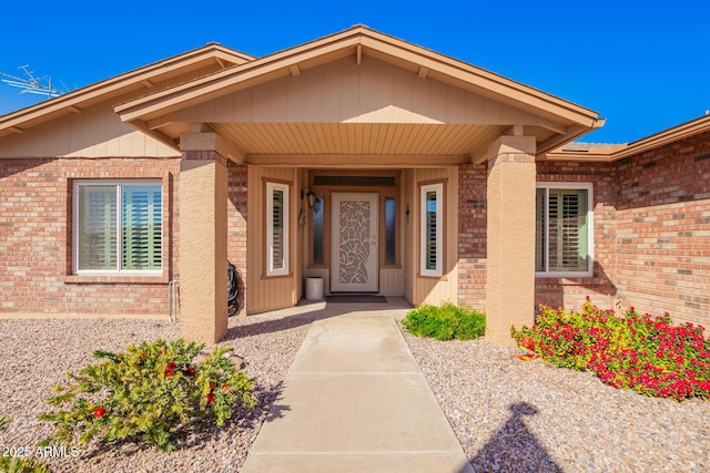 view of exterior entry with brick siding