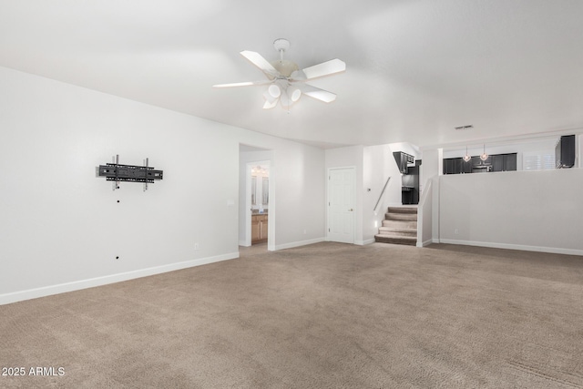 interior space featuring ceiling fan, stairway, carpet flooring, and baseboards