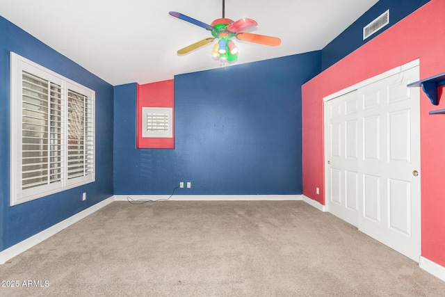 unfurnished bedroom with light carpet, ceiling fan, visible vents, and baseboards