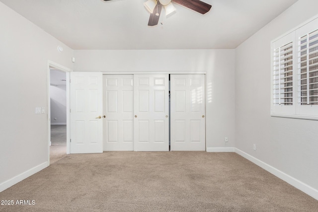 unfurnished bedroom featuring ceiling fan, carpet floors, a closet, and baseboards