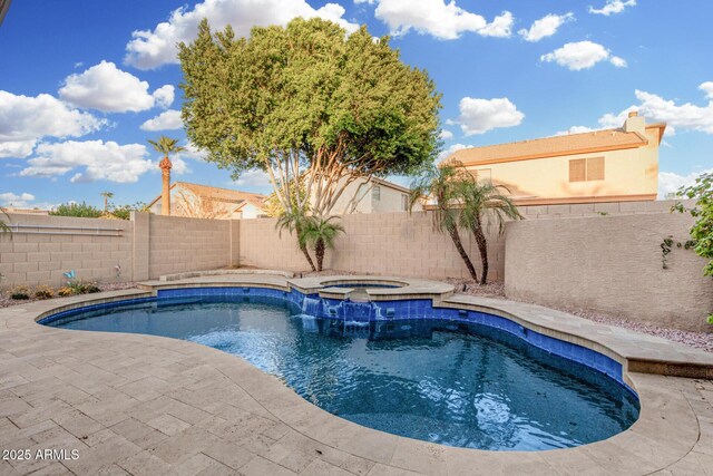 view of swimming pool featuring a pool with connected hot tub, a fenced backyard, and a patio