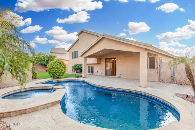 view of pool with a patio, fence, a fenced in pool, and an in ground hot tub