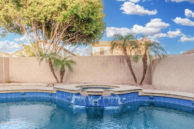 view of swimming pool featuring a fenced in pool, a fenced backyard, and an in ground hot tub