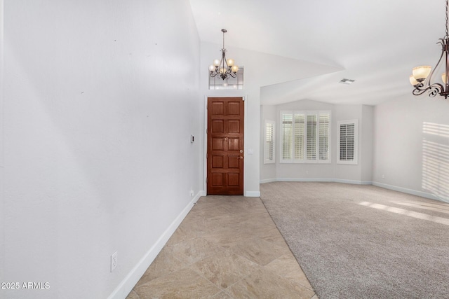 foyer entrance with vaulted ceiling, light colored carpet, visible vents, and an inviting chandelier