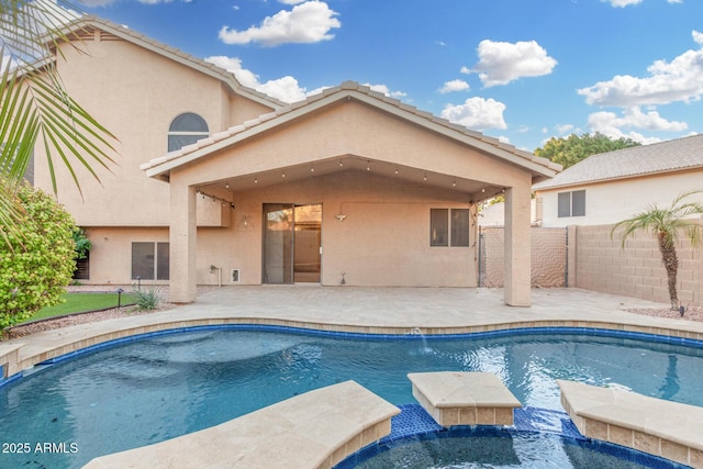 view of pool with a pool with connected hot tub and a fenced backyard