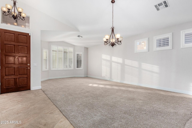 foyer entrance with light carpet, vaulted ceiling, visible vents, and a notable chandelier