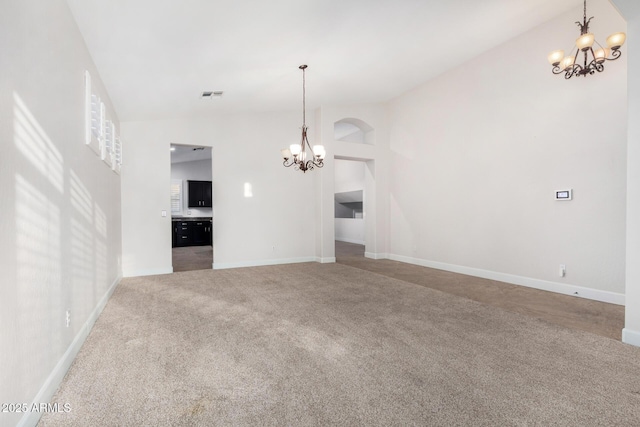 unfurnished living room with high vaulted ceiling, visible vents, carpet flooring, and an inviting chandelier