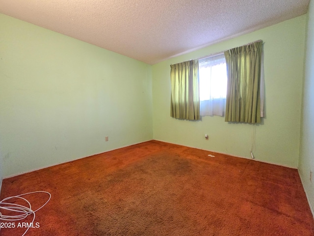 carpeted spare room with a textured ceiling