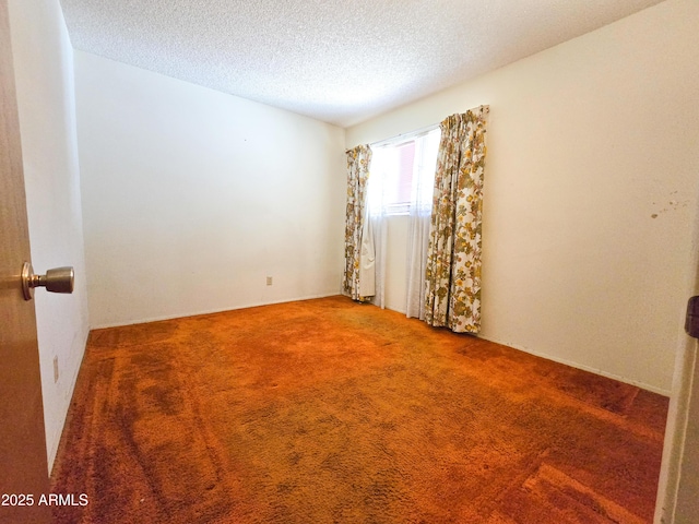 empty room featuring carpet floors and a textured ceiling