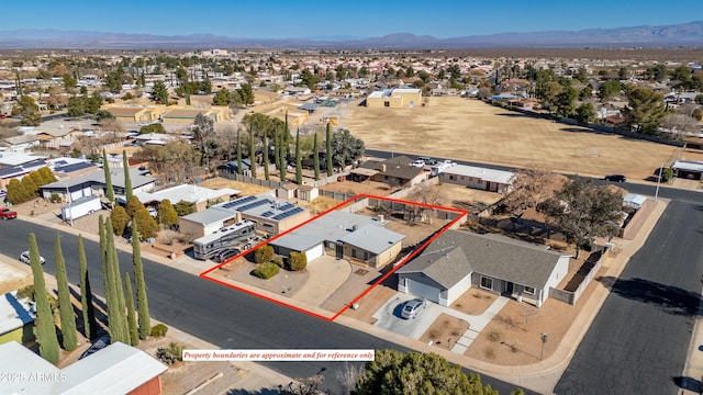 birds eye view of property featuring a mountain view