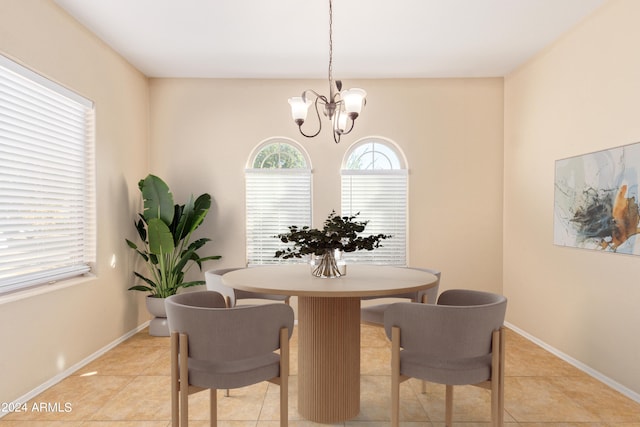 dining space with an inviting chandelier and light tile patterned flooring