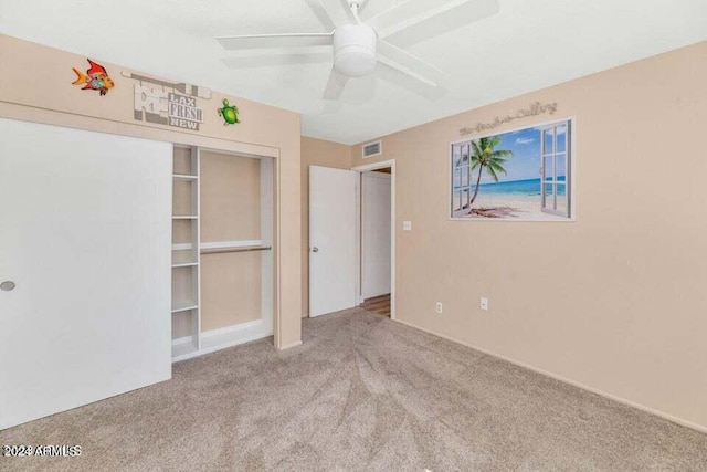 unfurnished bedroom featuring ceiling fan, light colored carpet, and a closet