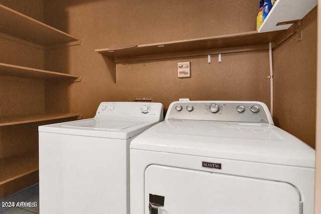 clothes washing area with washer and clothes dryer