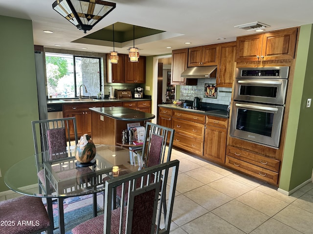 4856 E Cheryl Dr, Paradise Valley, AZ 85253 - kitchen featuring double oven, under cabinet range hood, dark countertops, decorative backsplash, and recessed lighting