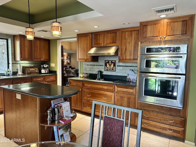 4856 E Cheryl Dr, Paradise Valley, AZ 85253 - kitchen featuring stainless steel double oven, light tile patterned flooring, under cabinet range hood, tasteful backsplash, and dark countertops