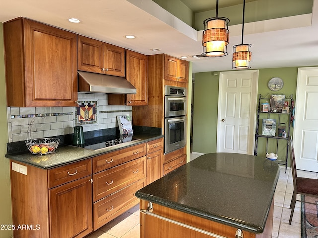 4856 E Cheryl Dr, Paradise Valley, AZ 85253 - kitchen featuring under cabinet range hood, double oven, black electric cooktop, brown cabinets, and light tile patterned floors