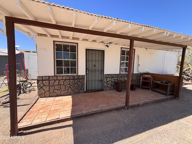 1226 N Mckinley Ave, Ajo, AZ 85321 - doorway to property featuring stone siding and stucco siding