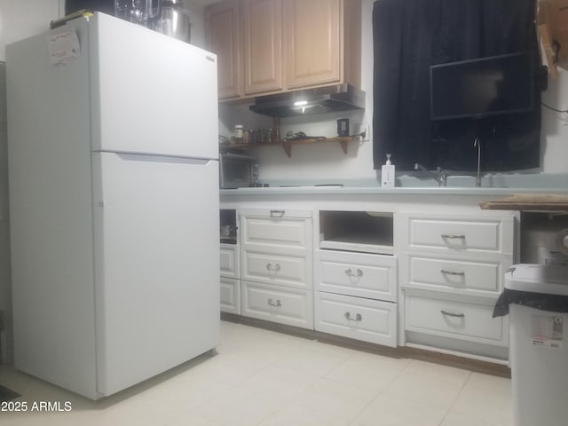 1226 N Mckinley Ave, Ajo, AZ 85321 - kitchen featuring freestanding refrigerator, under cabinet range hood, open shelves, light countertops, and white cabinets