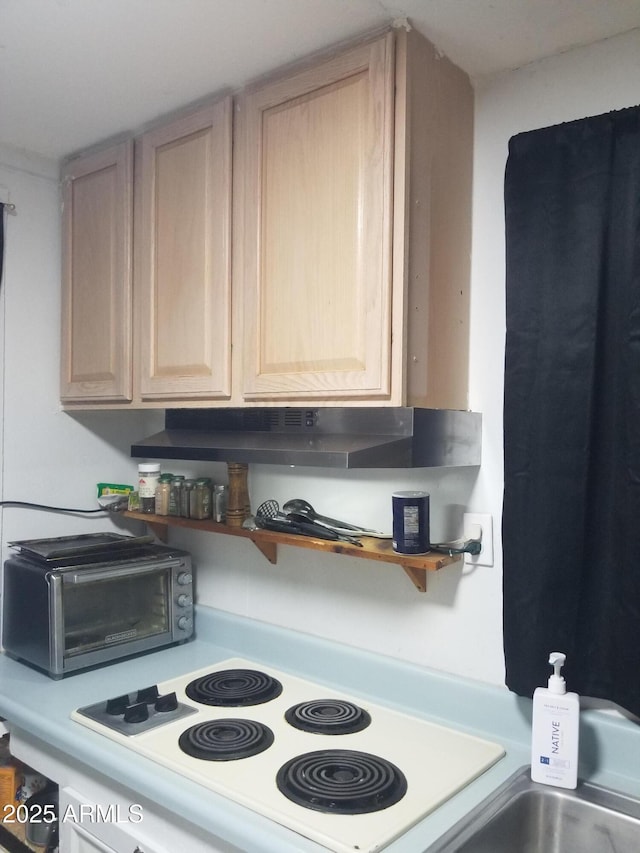 1226 N Mckinley Ave, Ajo, AZ 85321 - kitchen with light brown cabinets, range, under cabinet range hood, open shelves, and light countertops