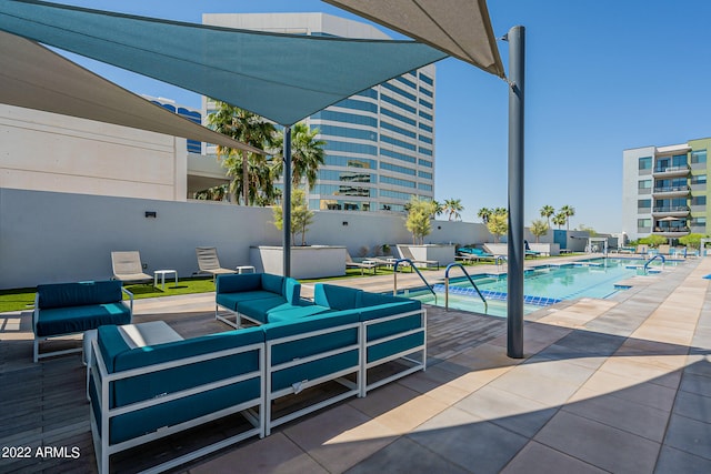 view of pool with an outdoor living space and a patio