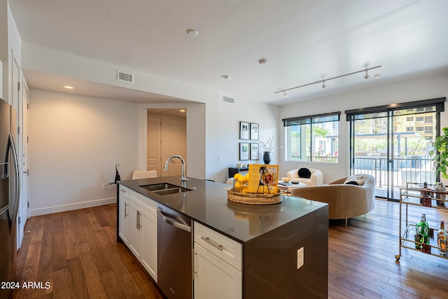 kitchen with an island with sink, white cabinets, sink, dark hardwood / wood-style flooring, and stainless steel dishwasher