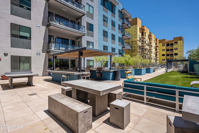 view of terrace with area for grilling and a balcony