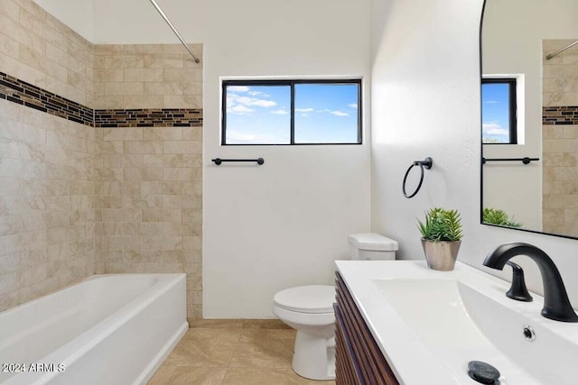 full bathroom featuring tiled shower / bath, vanity, tile patterned flooring, and toilet