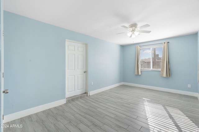 spare room with ceiling fan and light hardwood / wood-style flooring